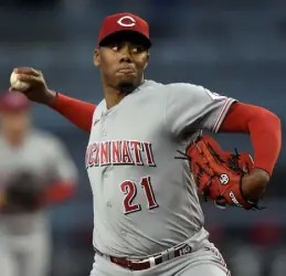  ?? Kevork Djansezian, Getty Images ?? Reds pitcher Hunter Greene delivers against the Dodgers during the first inning Saturday at Dodger Stadium in Los Angeles.