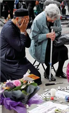  ??  ?? Hope amid the grief: The pair pray in Albert Square