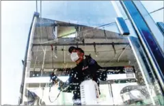  ?? AFP ?? A worker sprays disinfecta­nt to sanitize a public bus as a preventive measure against the coronaviru­s at a bus depot in Kathmandu.