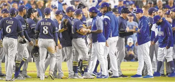  ?? MARK J. TERRILL/ASSOCIATED PRESS ?? Benches cleared after Milwaukee first baseman Jesus Aguilar and Los Angeles shortstop Manny Machado exchanged words during the 10th inning of Game 4 of the NLCS.