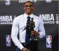  ??  ?? Russell Westbrook poses with his award.