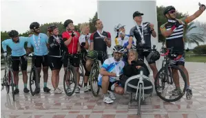  ?? Photo by Ryan Lim ?? Members of ‘seven-cyclists biking tour’ share a light moment during their peddling expedition to spread the importance of sport in daily life. The cyclists covered 460 kilometres across the country to mark the occasion of the UAE National Sports Day. —