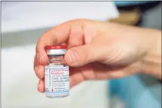  ?? TNS file photo ?? A healthcare profession­al holds a vial of the Moderna COVID-19 vaccine.