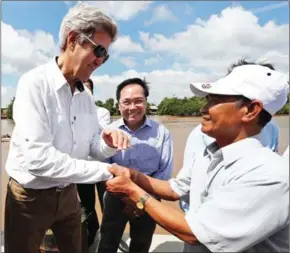  ?? ALEX BRANDON/AFP ?? US Secretary of State John Kerry (left) shakes hands with Vo Ban Tam, 70, who was a member of the former Viet Cong and who took part in the attack on Kerry’s boat on February 28, 1969, while on a tour of the region, in the Mekong River Delta, on...