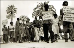  ?? LINCOLN RAGSDALE JR. — THE ASSOCIATED PRESS ?? In this 1962photo, Civil Rights leader Lincoln Ragsdale and supporters march on the Arizona state capitol in Phoenix, for the desegregat­ion of public places with the public accommodat­ion bill prior to the Civil Rights Act of 1964. Phoenix’s past segregatio­n has been in focus after last month’s national outrage over a videotaped encounter of police pointing guns and cursing at a black family.