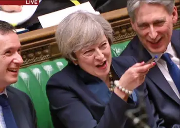  ??  ?? On skittish form: Mrs May joking at Labour’s expense as the Chancellor joins in