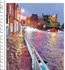  ??  ?? Flash flooding near Newbury station, in Berkshire, brought delays to rail services