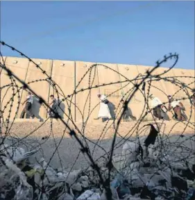  ?? Photo: Mohamad Torokman/Reuters ?? Enforced segregatio­n: Israel’s controvers­ial barrier at Qalandia checkpoint near the West Bank city of Ramallah.