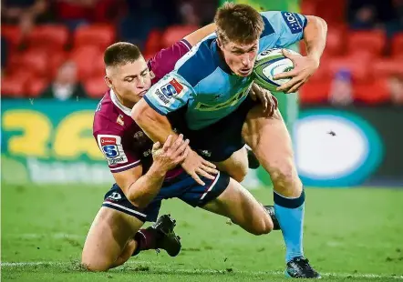  ?? — AFP ?? No way through: Waratahs’ alex Newsome (right) is tackled by reds’ James O’Connor in yesterday’s first rugby match in australia since the Covid-19 outbreak.