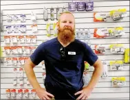  ?? Lynn/Atkins/The Weekly Vista ?? Trey Anson, the POA’s Trails and Outdoor Recreation manager, poses in front of some of the fishing gear sold at the Marina store last week. Although the store limits the number of customers inside at one time, most of the marina’s functions have not been affected by covid-19 precaution­s.