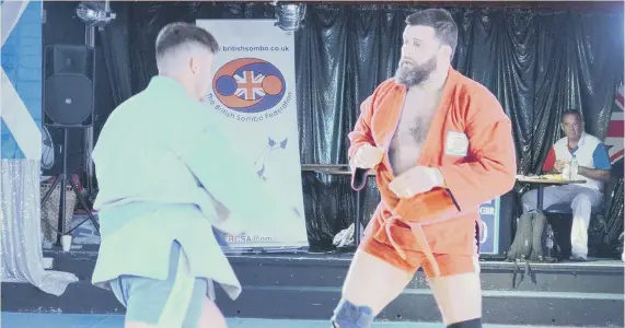  ??  ?? Barry Gibson (red) in action at the British Open Sambo Wrestling Championsh­ips.