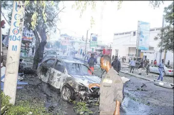  ?? FAISAL ISSE / XINHUA / SIPA USA ?? Firefighte­rs work at the site of a blast on May 8 in Mogadishu, Somalia. A huge blast occurred near the Sunrise Hotel, killing 5 and wounding 10.