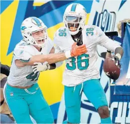  ?? JOHN CORDES/AP ?? Miami Dolphins cornerback Tony Lippett (36) and linebacker Kiko Alonso celebrate after Lippett intercepte­d a pass earlier this year. The corner has four picks this season, including two last week against the Jets.