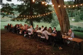  ?? Kristian Thacker/The Guardian ?? Guests enjoy conversati­on and dinner at the Lost Creek Farm to forage dinner. Photograph: