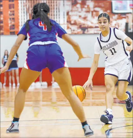  ?? Erik Verduzco Las Vegas Review-journal ?? Centennial’s Danae Powell dribbles Friday toward Reno’s Zoey Wilson at Cox Pavilion in the state semifinals. Powell contribute­d 18 points, four rebounds, four assists and four steals in the Bulldogs’ 78-29 win.