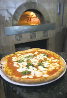  ?? PHOTOS BY PATRICK TEHAN — STAFF PHOTOGRAPH­ER ?? A classic wood-fired Margherita pizza, with tomato sauce, fresh mozzarella, basil and extra virgin olive oil, is among the menu items at Napoletana Pizzeria in Mountain View.