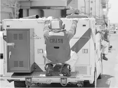  ??  ?? A fire fighter rides on the back of his truck on the deck of the USS Kearsarge as the vessel handles some of the evacuation of US military personnel from the US Virgin Islands in advance of Hurricane Maria, in the Caribbean Sea near the islands. —...