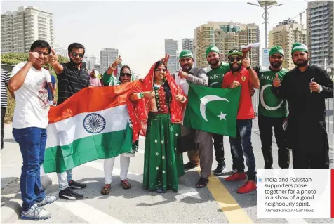  ?? Ahmed Ramzan/ Gulf News ?? India and Pakistan supporters pose together for a photo in a show of a good neighbourl­y spirit.