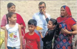  ?? HT PHOTO ?? Javelin thrower Neeraj Chopra’s family members sharing sweets at his native village Khandra in Panipat n district on Saturday.