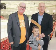  ?? SUBMITTED PHOTO ?? Stewart Matheson, right, poses with his grandson, Cailex Tournidis, and Membertou First Nation Chief Terry Paul, at the Membertou Sport and Wellness Centre after the century-old hockey stick owned by Matheson’s family was donated to Membertou Heritage...