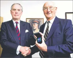  ??  ?? Brigadier (Retired) Brian Parritt, right, is presented with the clasp for his service in Cyprus in the 1960s by Lord Astor of Hever, Minister for Veterans’ Affairs