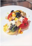  ??  ?? Tuerta’s Tomato Salad is comprised of blackberri­es, chimichurr­i and farmer’s cheese.