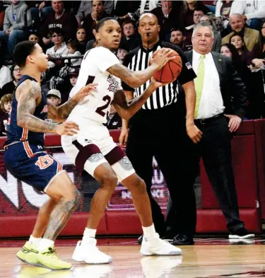  ??  ?? Auburn men’s basketball coach Bruce Pearl, right, looks on as one of his players defends against Mississipp­i State’s Tyson Carter earlier this season. (Photo by Jason Cleveland, SDN file)