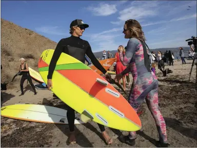  ?? LIPO CHING — STAFF PHOTOGRAPH­ER ?? From left, competitor­s Jamie Mitchell and Bianca Valenti greet each other at the opening ceremony of the 2018/2019World Surf League Big Wave Tour Mavericks Challenge at Mavericks Beach in Half Moon Bay on October 26.