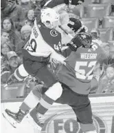  ?? WILFREDO LEE/AP PHOTOS ?? Avalanche defenseman Samuel Girard gets a lift from Panthers defenseman MacKenzie Weegar (52).