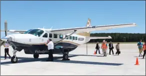  ??  ?? Passengers Disembark: Southern Airways Express pilot, Capt. Andrew Hargett, closes the door to the Cessna airplane after the plane touched down for the first time at the South Arkansas Regional Airport in El Dorado on Monday. Mark Cestari, executive...