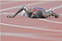  ?? AP PHOTO/PETR DAVID JOSEK ?? Paul Chelimo, of United States, lies on the track Friday after the final of the men’s 5,000-meters at the 2020 Summer Olympics in Tokyo. The Games come to a close Sunday.