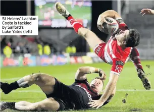  ??  ?? St Helens’ Lachlan Coote is tackled by Salford’s Luke Yates (left)