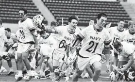  ?? PAUL W. GILLESPIE/BALTIMORE SUN MEDIA ?? Navy celebrates its upset of Army in men’s lacrosse Saturday at Navy-Marine Corps Memorial Stadium.