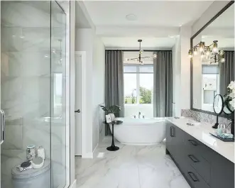  ??  ?? The focal point of the sunny and spa-like ensuite is the chic free-standing tub that’s backlit by a window.