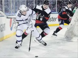  ?? PATRICK MCDERMOTT GETTY IMAGES ?? Mitch Marner of the Toronto Maple Leafs controls the puck against Washington’s Dmitry Orlov at United States Naval Academy on Sunday in Annapolis, Md.