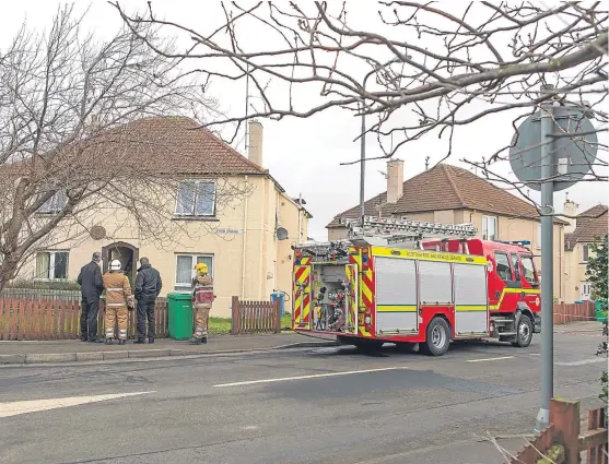  ?? Picture: Steven Brown. ?? Scottish Fire and Rescue Service staff and police at the scene of the fire.