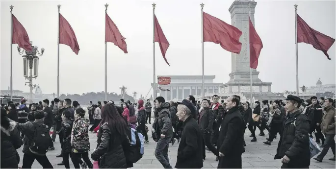  ?? QILAI SHEN / BLOOMBERG NEWS ?? Pedestrian­s at Tiananmen Square in Beijing. Under President Xi Jinping, China has tightened the screws of repression and censorship, Western nations complain.