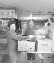  ?? COURTESY ?? Geneviève Ricard and Olivier Girondier preparing food for distributi­on.