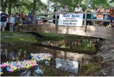  ?? (NewsTimes file) ?? People gather to watch the plastic ducks to cross under the first bridge during the Duck Race at the 44th Annual Smackover Oil Town Festival on Saturday, June 20, 2015. The 2020 Oil Town Festival was canceled due to COVID19.