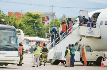  ?? ODELYN JOSEPH/AP ?? Haitians who were deported from the United States disembark Sept. 19, 2021, at the Toussaint L’Ouverture Internatio­nal Airport in Port au Prince, Haiti. More than 20,000 Haitians have been deported from the U.S. in the past year.