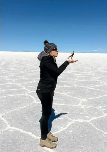  ?? LAMPE REBECCA ?? This photo was taken by our driver on our day tour to the Salar de Uyuni, in Bolivia. While it looks like I blew my partner David Meek away here, he turned the tables and blew me away a few weeks later by proposing in Santiago, Chile. We travelled...