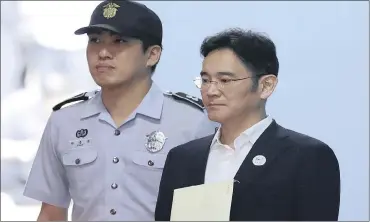  ?? PHOTO: GETTY IMAGES ?? Jay Y Lee, vice-chairperso­n of Samsung Electronic­s, leaves after his trial at the Seoul Central District Court on Friday. Lee was slapped with a five-year jail term. He has filed an appeal against the sentence for bribery, among other charges.