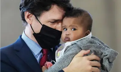  ?? Photograph: Canadian Press/Rex/Shuttersto­ck ?? The PM, Justin Trudeau, holds five-month-old Manal Hussen as the federal government reaches an agreement with Ontario on subsidized childcare.