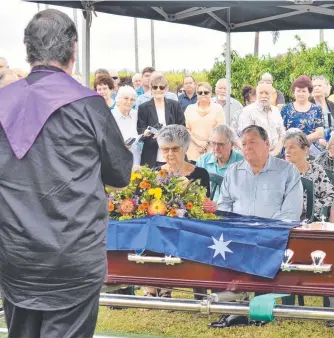  ?? ?? Father Damien Mcgrath extending his sympathies on behalf of the community to the Butler family, including Gloria, Ricky and Patrick seated in the front row. About 150 people attended the solemn ceremony at the New Ingham Cemetery on Monday morning. Picture: Cameron Bates