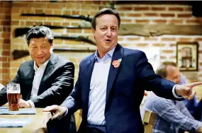  ?? ?? David Cameron took Chinese President Xi Jinping to a pub near Chequers as part of his push for a golden era" of Chinese relations. Pic by PA MEDIA
