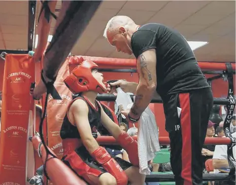  ??  ?? Lambton Street boxing trainer John Pollock, 72, who died after testing positive for the coronaviru­s, is seen here doing what he loved best – coaching.