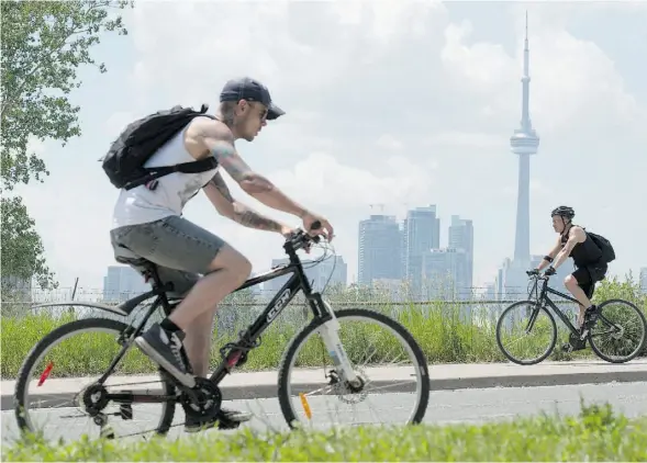  ?? FRANK GUNN/THE CANADIAN PRESS ?? As more cyclists hop on bikes for leisure rides and commutes this summer, experts say it’s important to wear the right gear and follow the rules of the road.