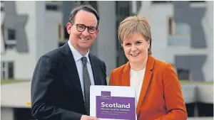  ?? Picture: PA. ?? ‘Stability and certainty’: First Minister Nicola Sturgeon receives the report from commission chairman Andrew Wilson at Holyrood.