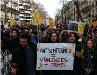  ?? (Gonzalo Fuentes/Reuters) ?? PEOPLE ATTEND a gathering in Paris in March against antisemiti­sm.