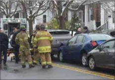  ?? PETE BANNAN - MEDIANEWS GROUP ?? Chester firefighte­rs asist an accident victim on Ninth Street near Pennell Street about 1:30 p.m. Monday.